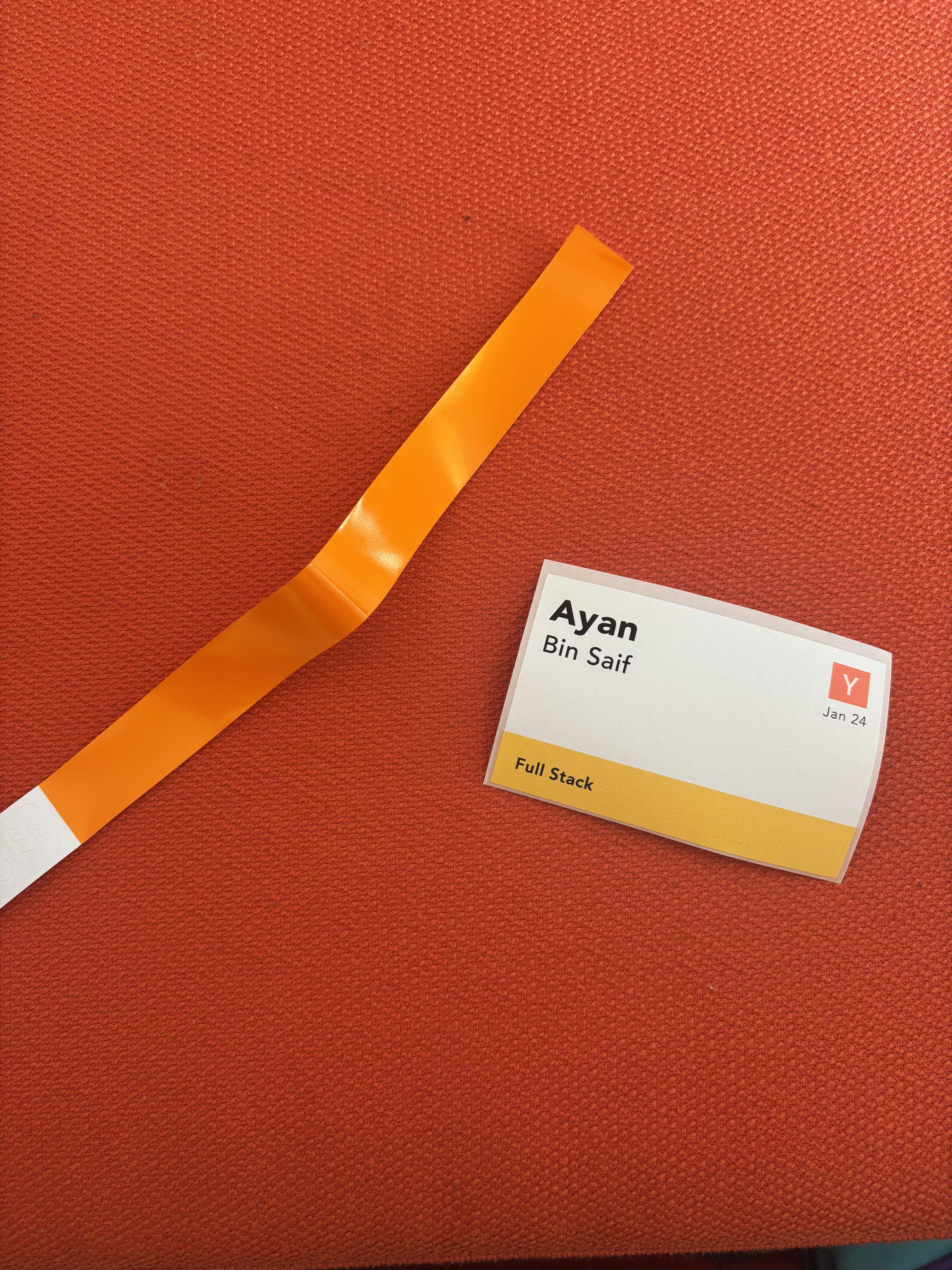 a Y Combinator hackathon wristband and name badge reading Ayan Bin Saif, Full Stack