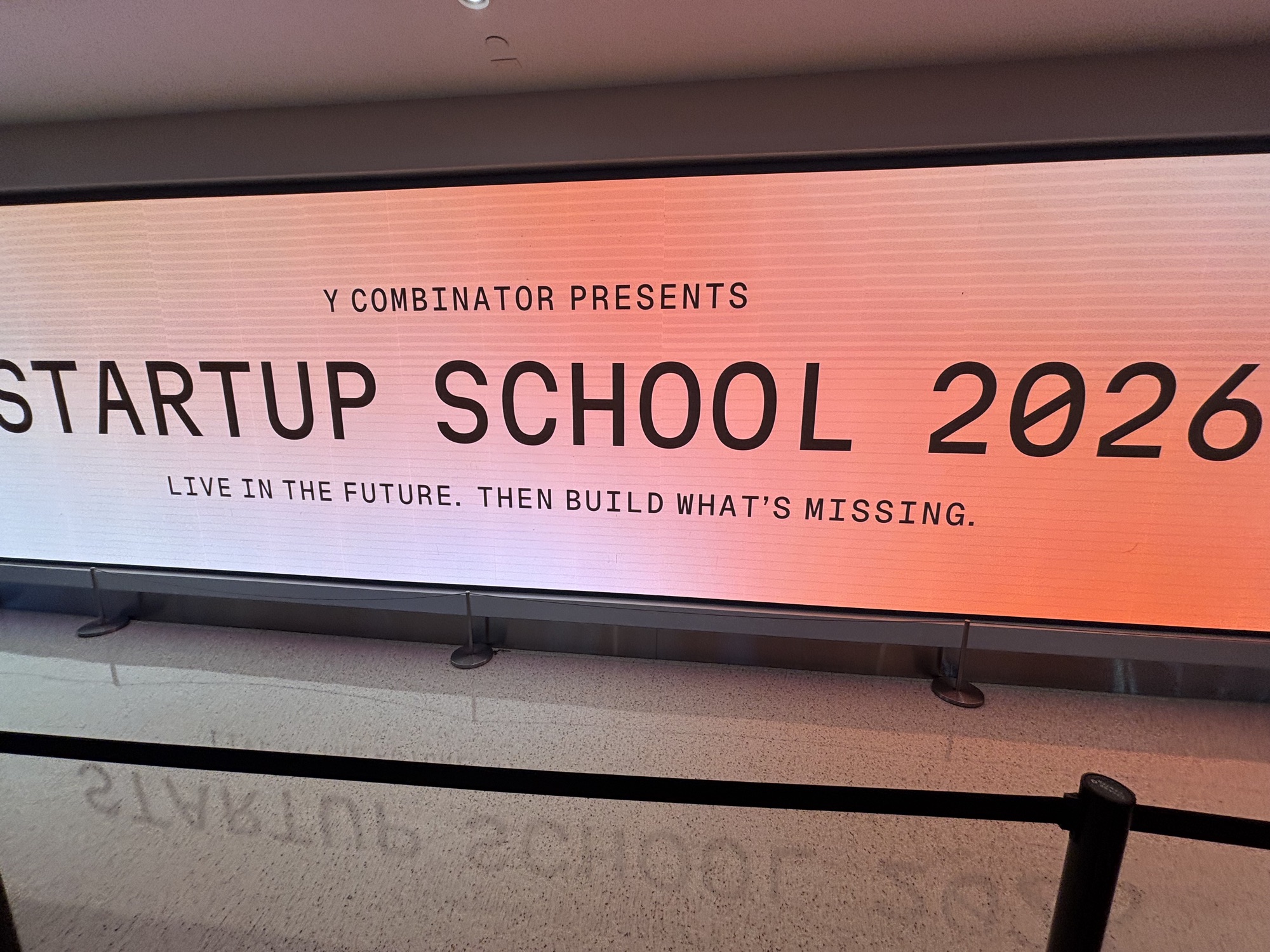 a large screen inside the Chase Center reading Y Combinator presents Startup School 2026 โ live in the future, then build what's missing